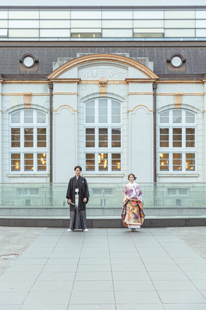 平安神宮周辺の図書館を背景での色打掛の花嫁と新郎