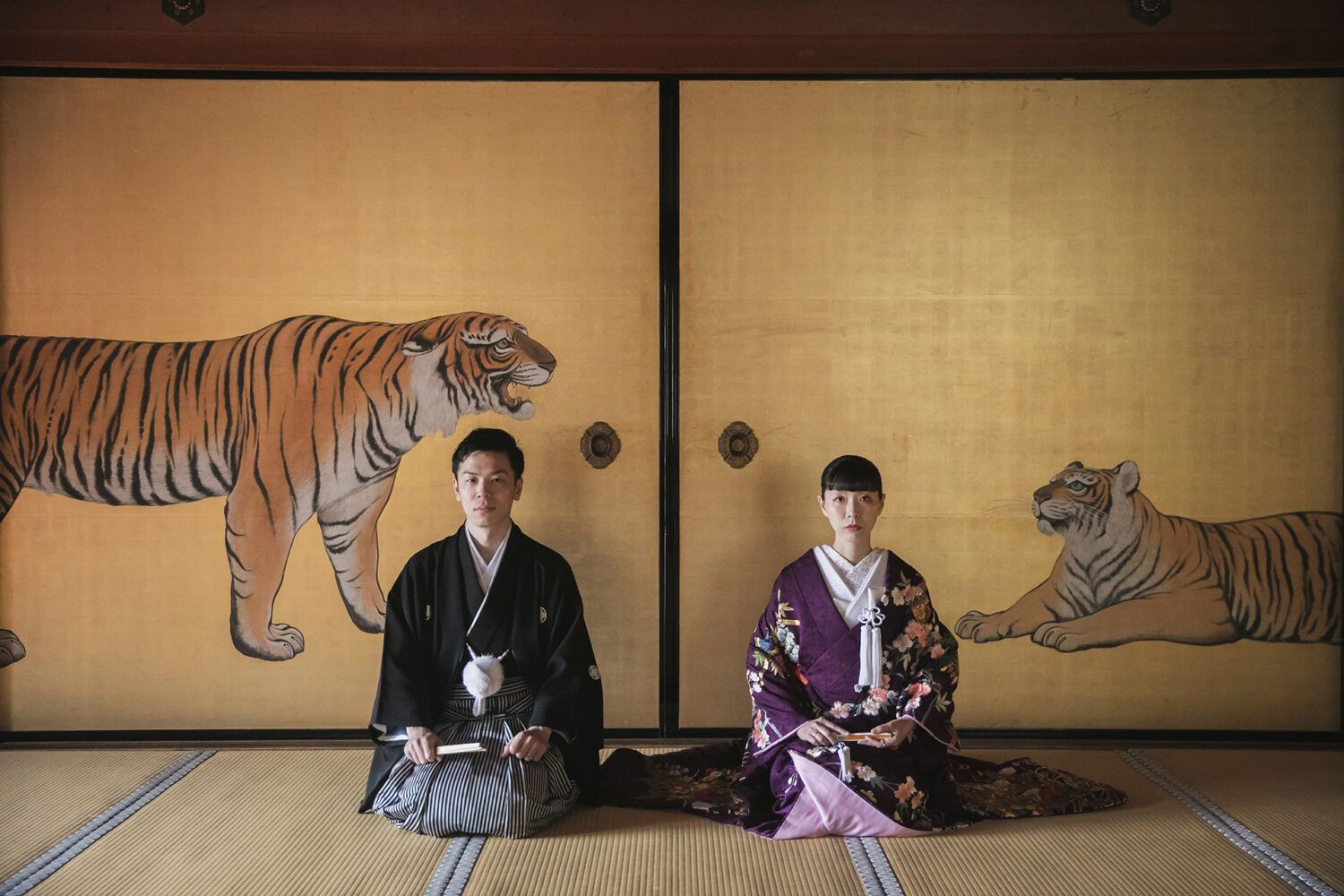 金戒光明寺の黄金の虎の襖の前で色打掛の花嫁と新郎