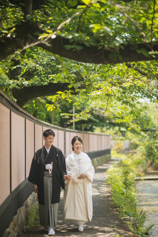 平安神宮周辺の白川疎水を歩く白無垢姿の花嫁と新郎